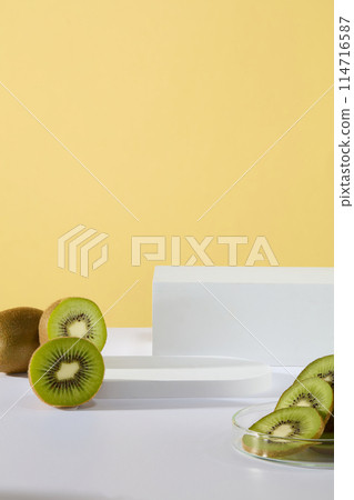 Abstract composition in minimal design with few empty podiums and fresh kiwis. Due to the high Vitamin C content, kiwis can help to support the immune system 114716587
