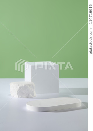 Several white podiums in geometric shapes are featured. Pastel green background. Product presentation, mockup, show cosmetic product, Podium, stage pedestal or platform 114716616