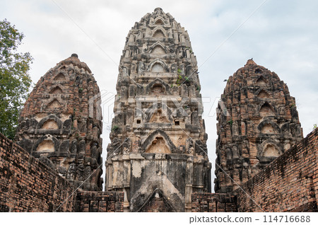 The three prangs (pagoda) in Wat Si Sawai temple one of the oldest temples in Sukhothai. Wat Si Sawai initially started off as a Hindu temple during the Khmer period. The three prangs (pagoda) in Wat Si Sawai temple one of the oldest temples in Sukhothai. Wat Si Sawai initially started off as a Hindu temple during the Khmer period. 114716688