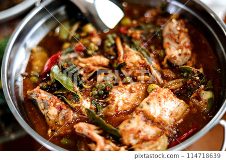 Thai hot and spicy clear red curry with fish and mixed vegetable.  114718639