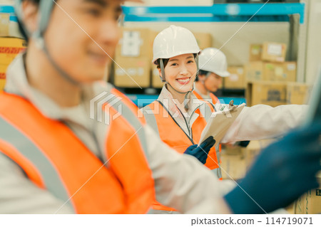 Logistics team working in warehouse 114719071