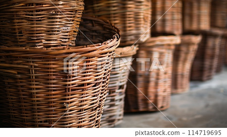 Exquisite handwoven wicker baskets, meticulously arranged. 114719695