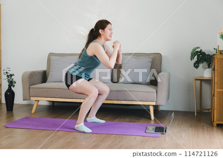 Asian young woman doing stretching exercise on mat yoga, fitness exercises. Healthy lifestyle Calmness and relax at home. Asian young woman doing stretching exercise on mat yoga, fitness exercises. Healthy lifestyle Calmness and relax at home. 114721126
