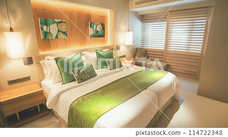 A cozy bedroom with beautiful bright accents and lots of natural light. 114722348