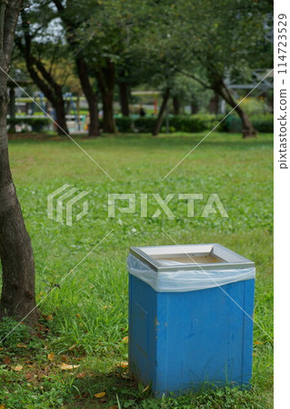 Blue trash can in the park Blue trash can in the park 114723529