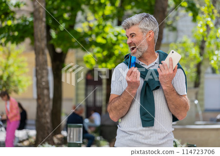 Shocked man trying to pay online shopping with smartphone blocked credit card lack of money balance 114723706