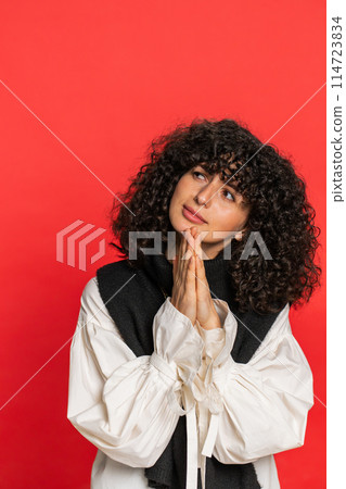 Caucasian young woman praying making wish, asking hopeful help begging apology meditation imploring 114723834
