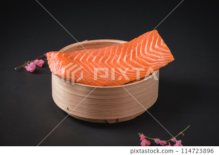 Raw Salmon on Dim Sum Bamboo Steamer Basket 114723896