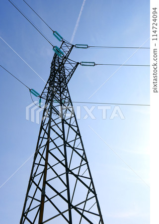 HIgh voltage transmission network silhouette over the sky 114724094