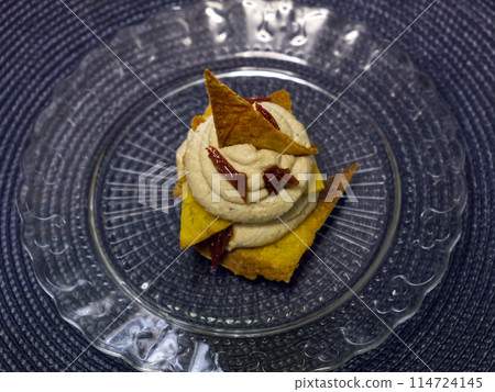 flat lay of chickpea humus with corn chips and dried tomatoes 114724145