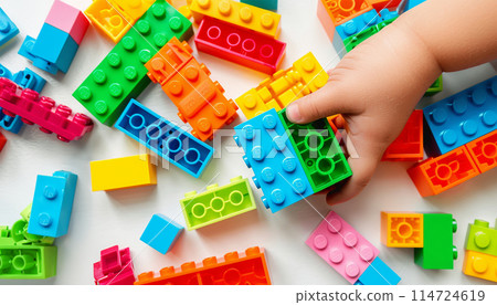 Kid hand building up a wall by stacking up the colorful wall block brick toy for banner, children sale promotion, flyer, online shop, poster, web, ads, and social media. Toddler Playing with colorful Kid hand building up a wall by stacking up the colorful wall block brick toy for banner, children sale promotion, flyer, online shop, poster, web, ads, and social media. Toddler Playing with colorful 114724619