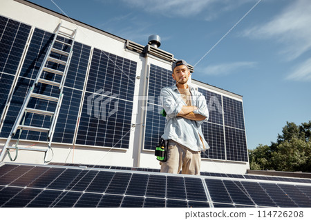 Man on a rooftop with solar panels 114726208