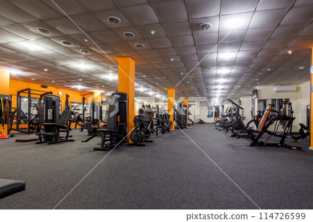 Exercise equipment in an empty gym Exercise equipment in an empty gym 114726599