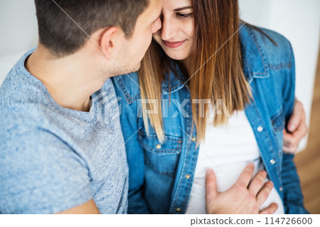 Pregnant woman and her partner, touching her belly. Pregnant woman and her partner, touching her belly. 114726600