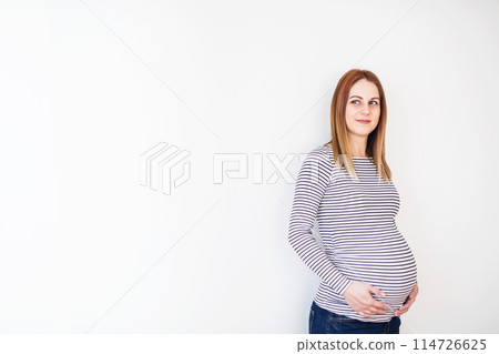 Beautiful pregnant woman touching her belly. Beautiful pregnant woman touching her belly. 114726625