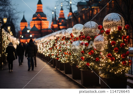 People walking down a Christmasdecorated sidewalk 114726645
