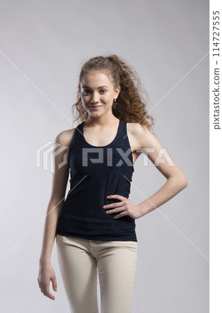 Portrait of a gorgeous teenage girl with curly hair. Studio shot, white background with copy space Portrait of a gorgeous teenage girl with curly hair. Studio shot, white background with copy space 114727555