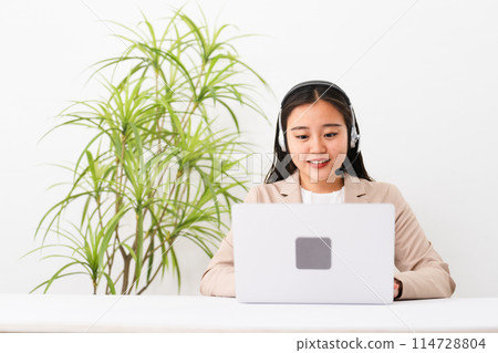 Young female operator operating a personal computer Business image Young female operator operating a personal computer Business image 114728804