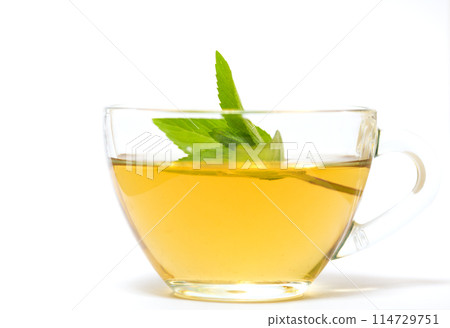 Glass transparent cup with tea and green mint leaf Glass transparent cup with tea and green mint leaf 114729751