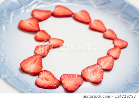 Beautiful heart symbol from chopped red juicy strawberry 114729758