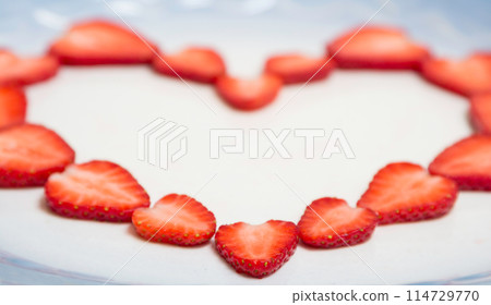 Beautiful heart symbol from chopped red juicy strawberry 114729770