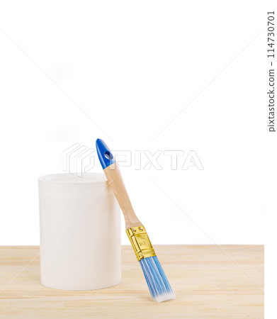 white paint with a brush on a wooden background with texture 114730701