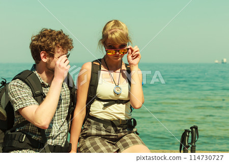 People tourists hiking by sea ocean. 114730727