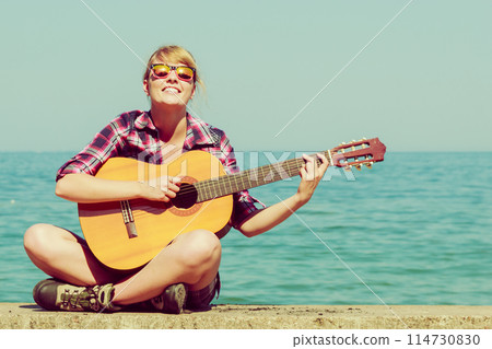 Young woman with guitar outdoor Young woman with guitar outdoor 114730830