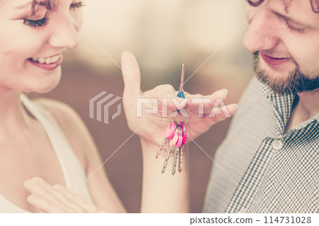 Couple showing their new house keys Couple showing their new house keys 114731028