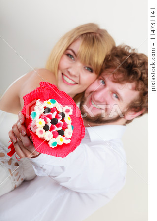 Couple with candy bunch flowers. Love. Couple with candy bunch flowers. Love. 114731141