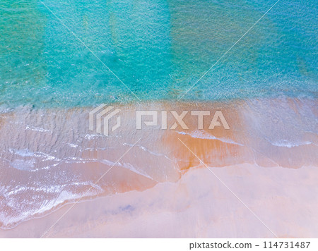 Aerial view of sea crashing waves White foaming waves on beach sand,Top view beach sea surface, Nature sea beach sand background Aerial view of sea crashing waves White foaming waves on beach sand,Top view beach sea surface, Nature sea beach sand background 114731487