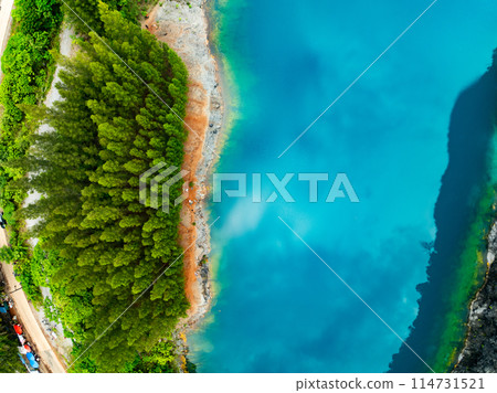 Aerial view of amazing pond in tropical rainforest with mountain rocks peak, Beautiful water surface in Phang Nga Thailand 114731521
