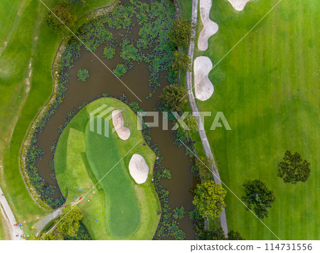 Aerial view of beautiful green golf field fairway and putting green, Top down image for sport background and travel nature background, Amazing green nature view Aerial view of beautiful green golf field fairway and putting green, Top down image for sport background and travel nature background, Amazing green nature view 114731556