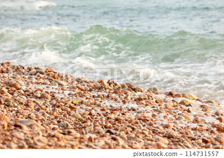 Pebble stones on the shore close up background Pebble stones on the shore close up background 114731557
