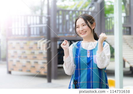 Nursery teacher working hard in the playground, motivated image with fist pump Nursery teacher working hard in the playground, motivated image with fist pump 114731638