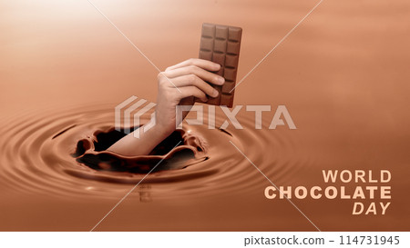 Close up human hand holding a chocolate bar that appears on the surface of a chocolate liquid, concept of giving on world chocolate day. Sweet and energy snack. 114731945