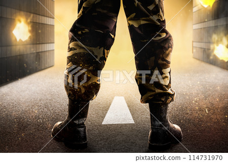 Soldier feet with military boots standing with fire and explosion 114731970