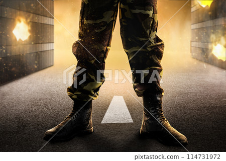 Soldier feet with military boots standing with fire and explosion Soldier feet with military boots standing with fire and explosion 114731972
