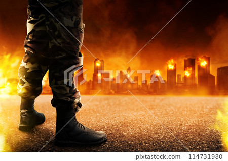 Image of demolished city in  from military aggression at night with fire and appearance of an army boots appearance. 114731980