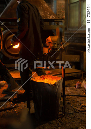 Foundry ladle with molten metal in workshop of metallurgical plant 114732664
