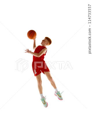 Full-length dynamic image of boy, basketball player in motion training, throwing ball in jump isolated on white studio background Full-length dynamic image of boy, basketball player in motion training, throwing ball in jump isolated on white studio background 114733557