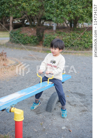 Boy playing with seesaw 114734157