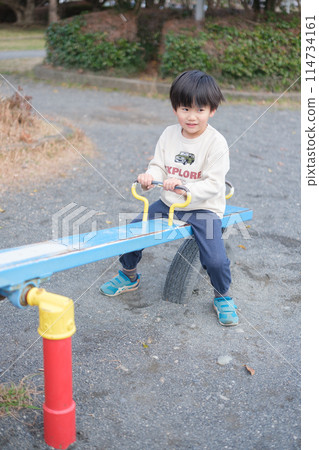 Boy playing with seesaw 114734161