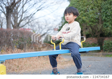 Boy playing with seesaw 114734167