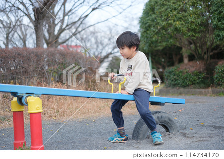 Boy playing with seesaw 114734170