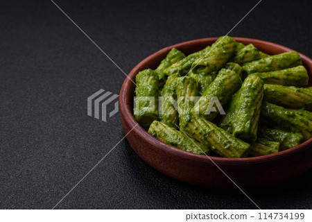 Delicious pasta with spinach sauce, olive oil and parmesan cheese 114734199