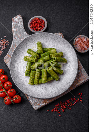 Delicious pasta with spinach sauce, olive oil and parmesan cheese Delicious pasta with spinach sauce, olive oil and parmesan cheese 114734220