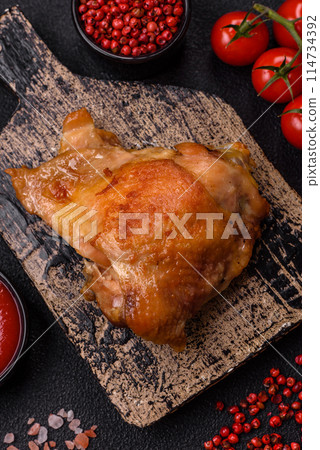 Delicious juicy chicken thighs baked on the grill with salt Delicious juicy chicken thighs baked on the grill with salt 114734392