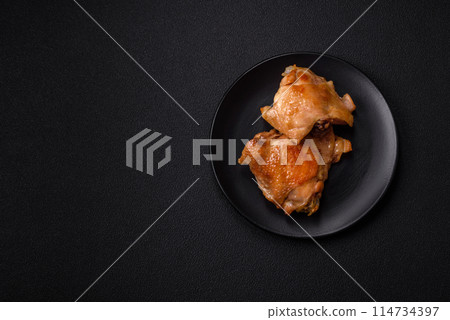 Delicious juicy chicken thighs baked on the grill with salt 114734397