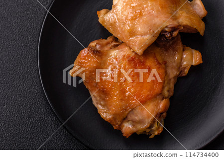 Delicious juicy chicken thighs baked on the grill with salt Delicious juicy chicken thighs baked on the grill with salt 114734400